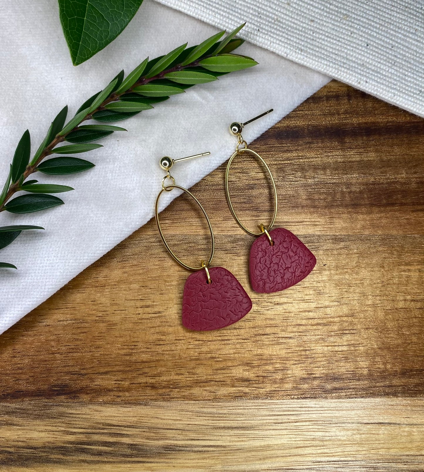 Statement dangles - textured burgundy rounded trapeziums with gold oval