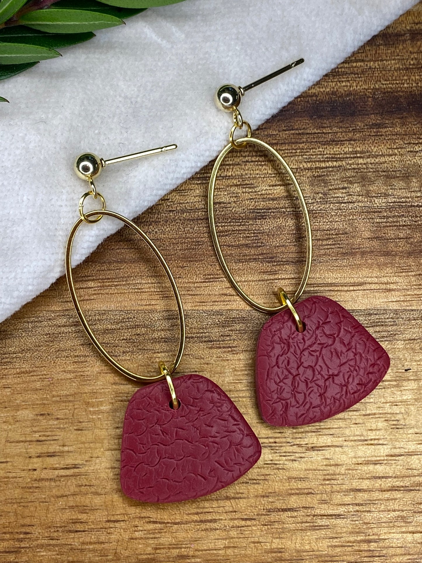 Statement dangles - textured burgundy rounded trapeziums with gold oval