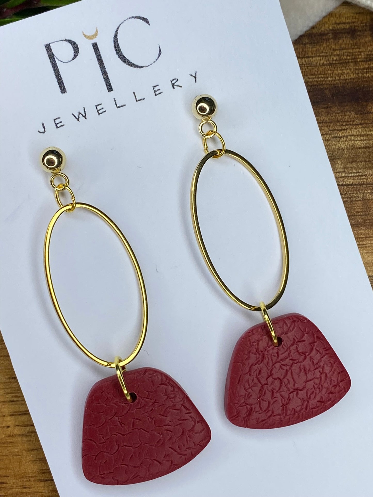 Statement dangles - textured burgundy rounded trapeziums with gold oval
