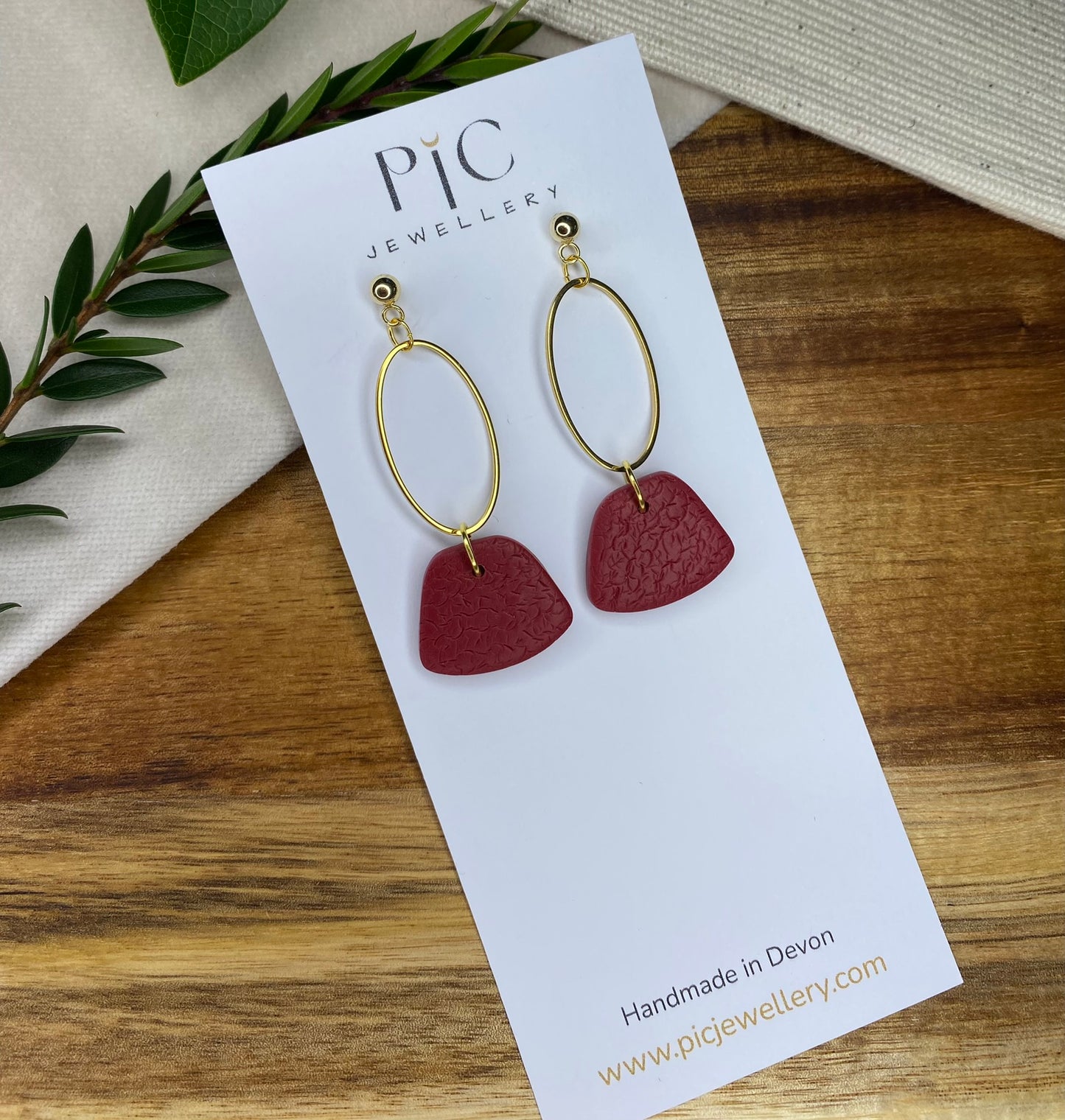 Statement dangles - textured burgundy rounded trapeziums with gold oval