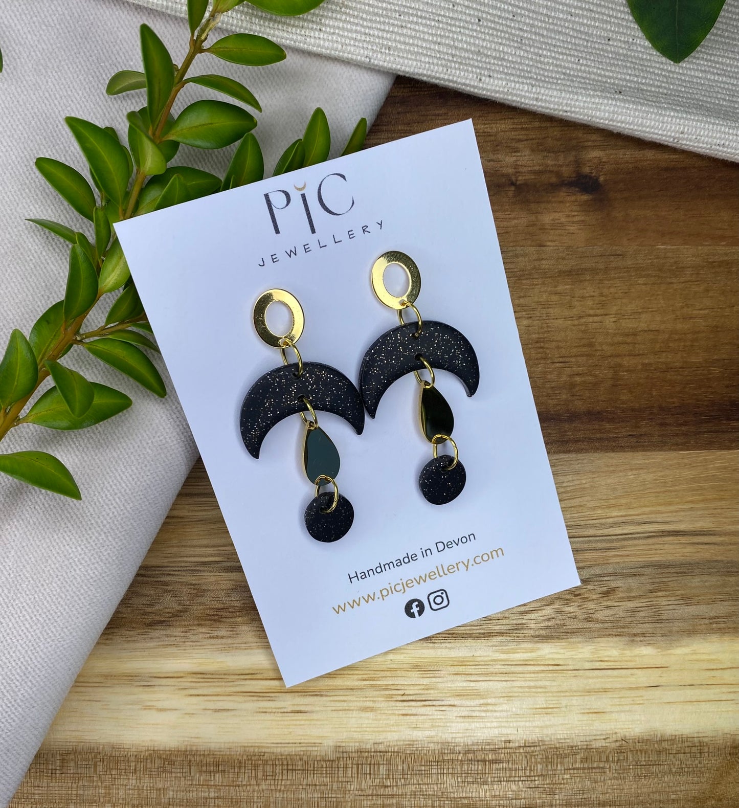 Statement dangles - black and gold glitter moons with gold metal teardrop