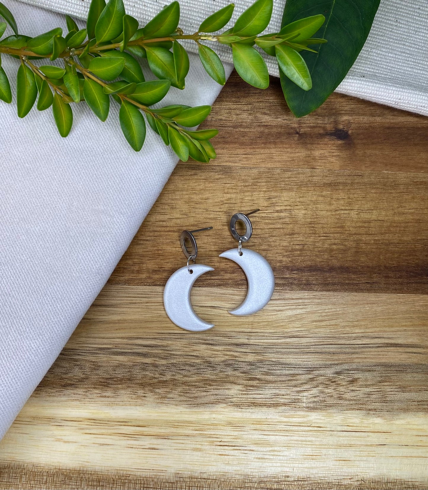 Medium dangles - pearlescent crescent moons with open oval stud
