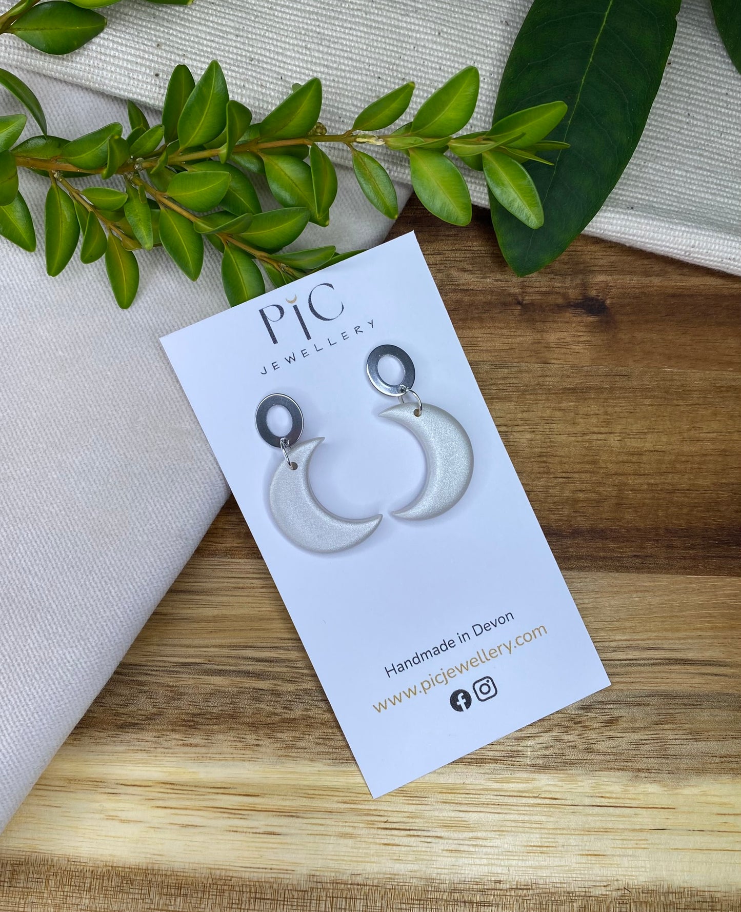 Medium dangles - pearlescent crescent moons with open oval stud