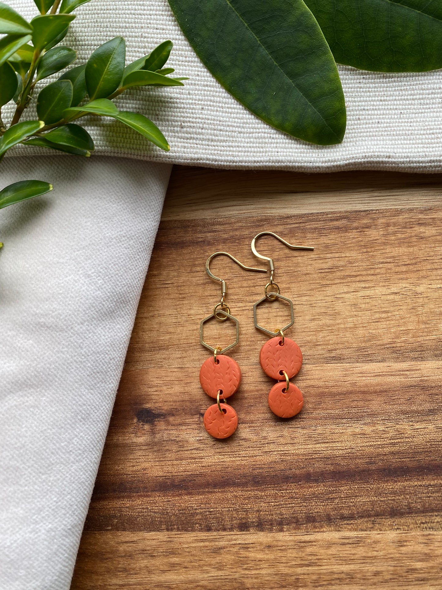 Statement dangles - textured orange circles and gold hexagon