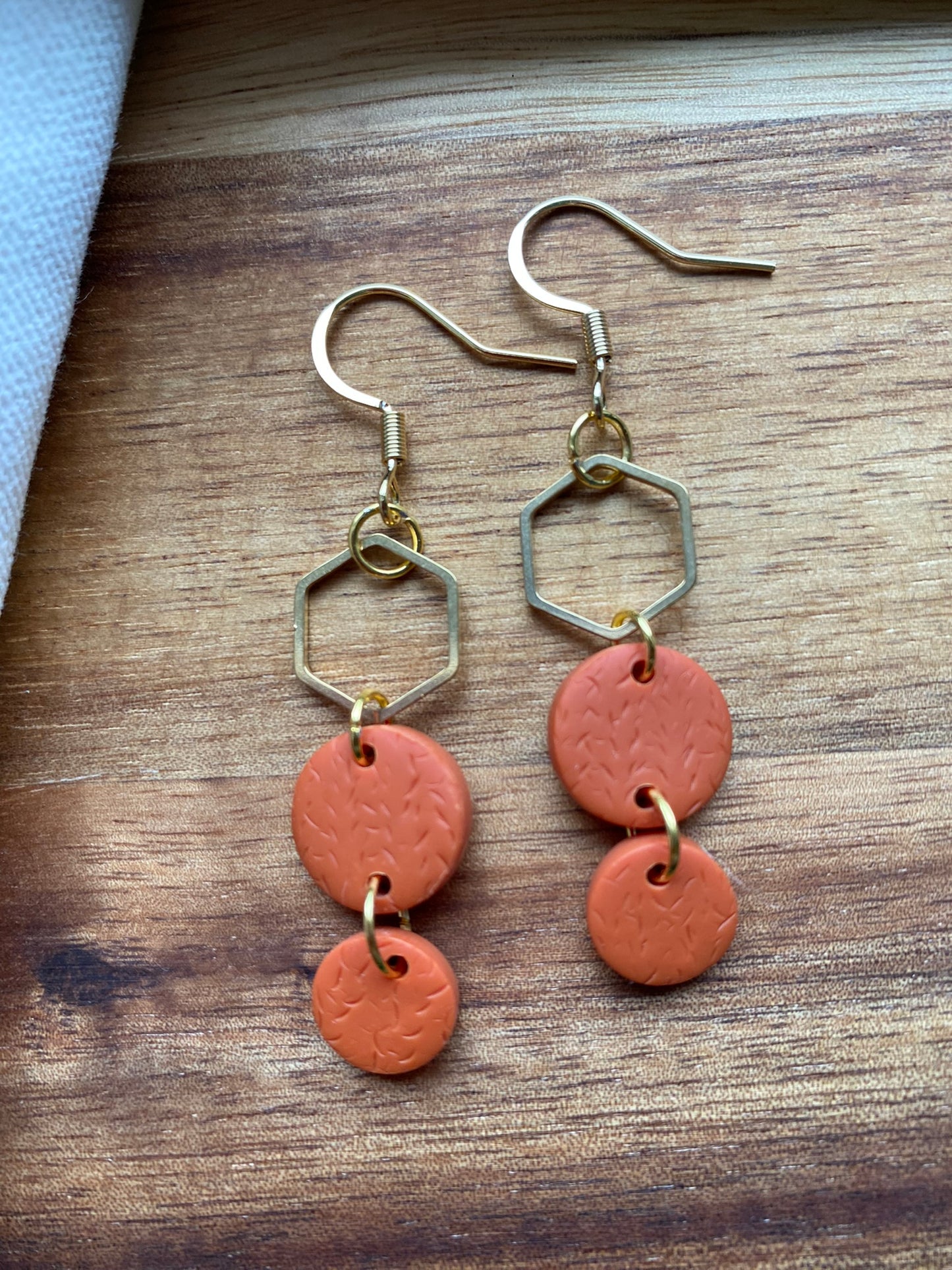 Statement dangles - textured orange circles and gold hexagon