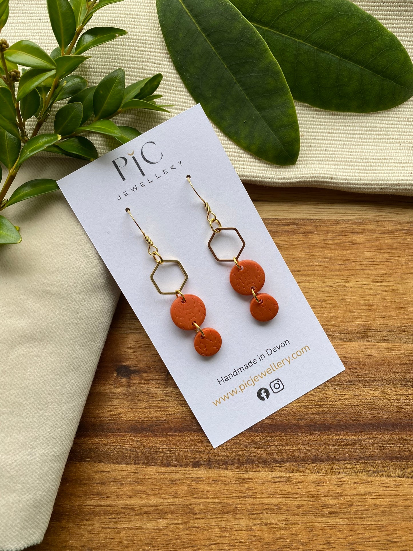 Statement dangles - textured orange circles and gold hexagon