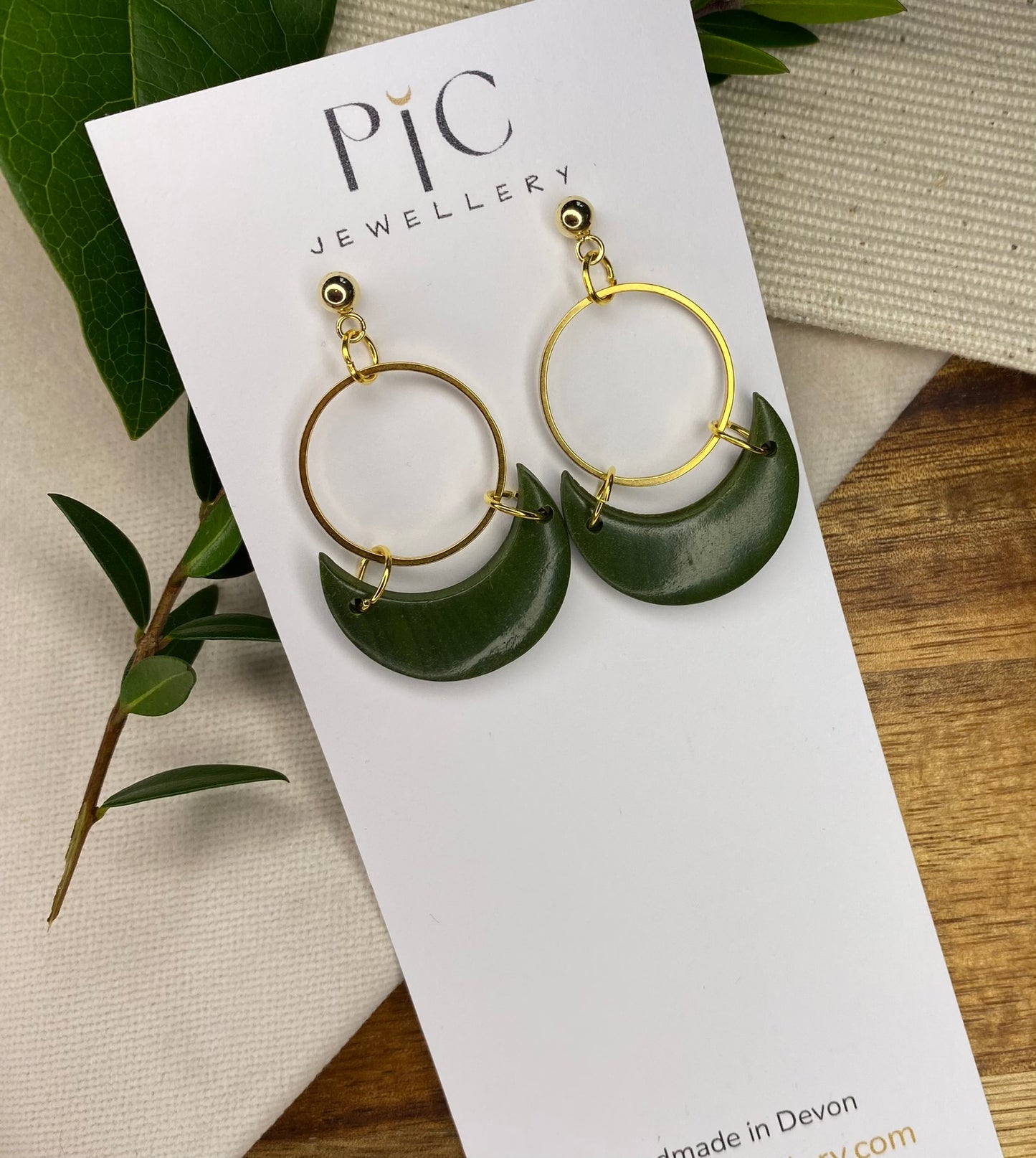 Statement dangles - green moons with gold circle