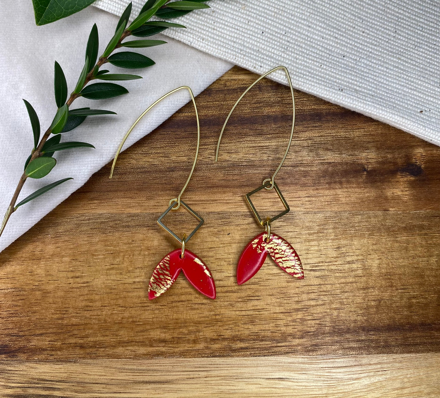 Statement dangles - red and gold fish tail with gold metal rhombus