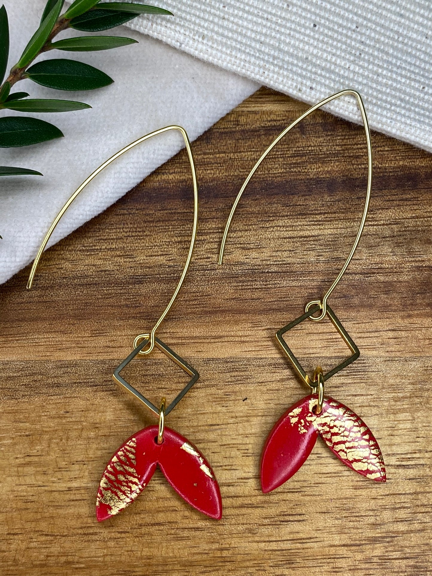 Statement dangles - red and gold fish tail with gold metal rhombus