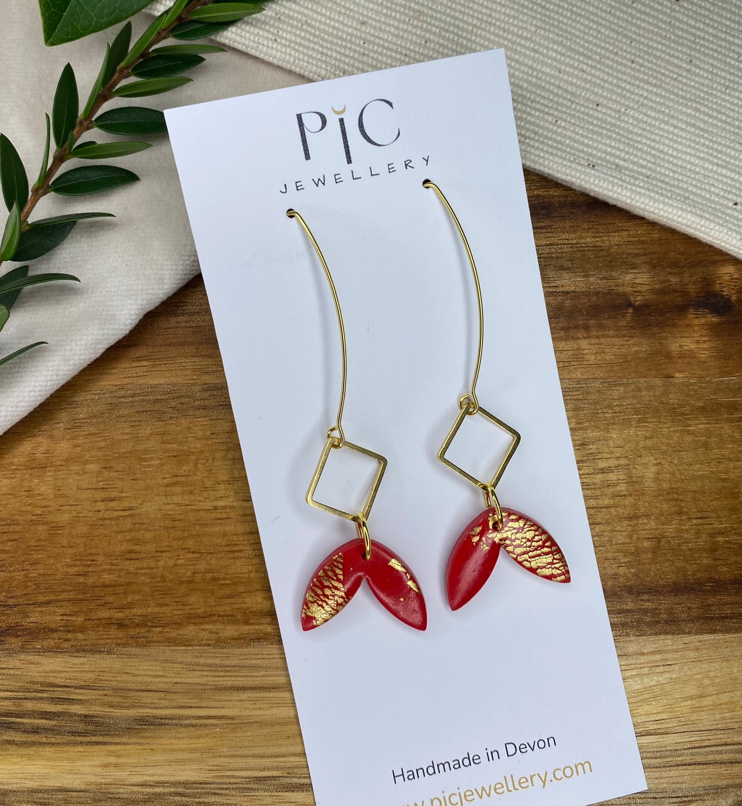 Statement dangles - red and gold fish tail with gold metal rhombus