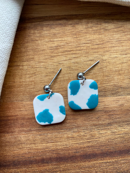 Dinky dangles - white and teal cow print squares