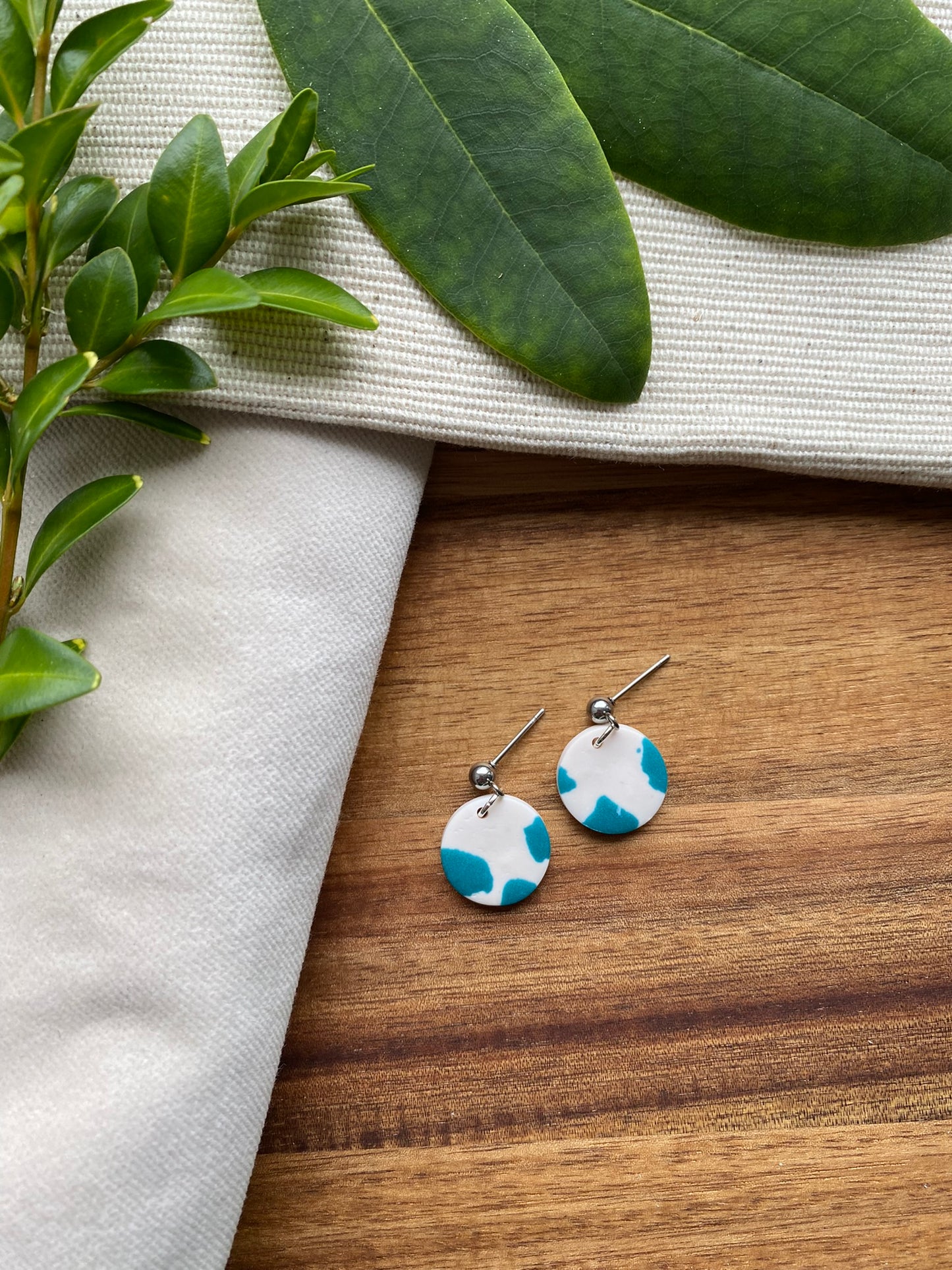 Dinky dangles - white and teal cow print circles