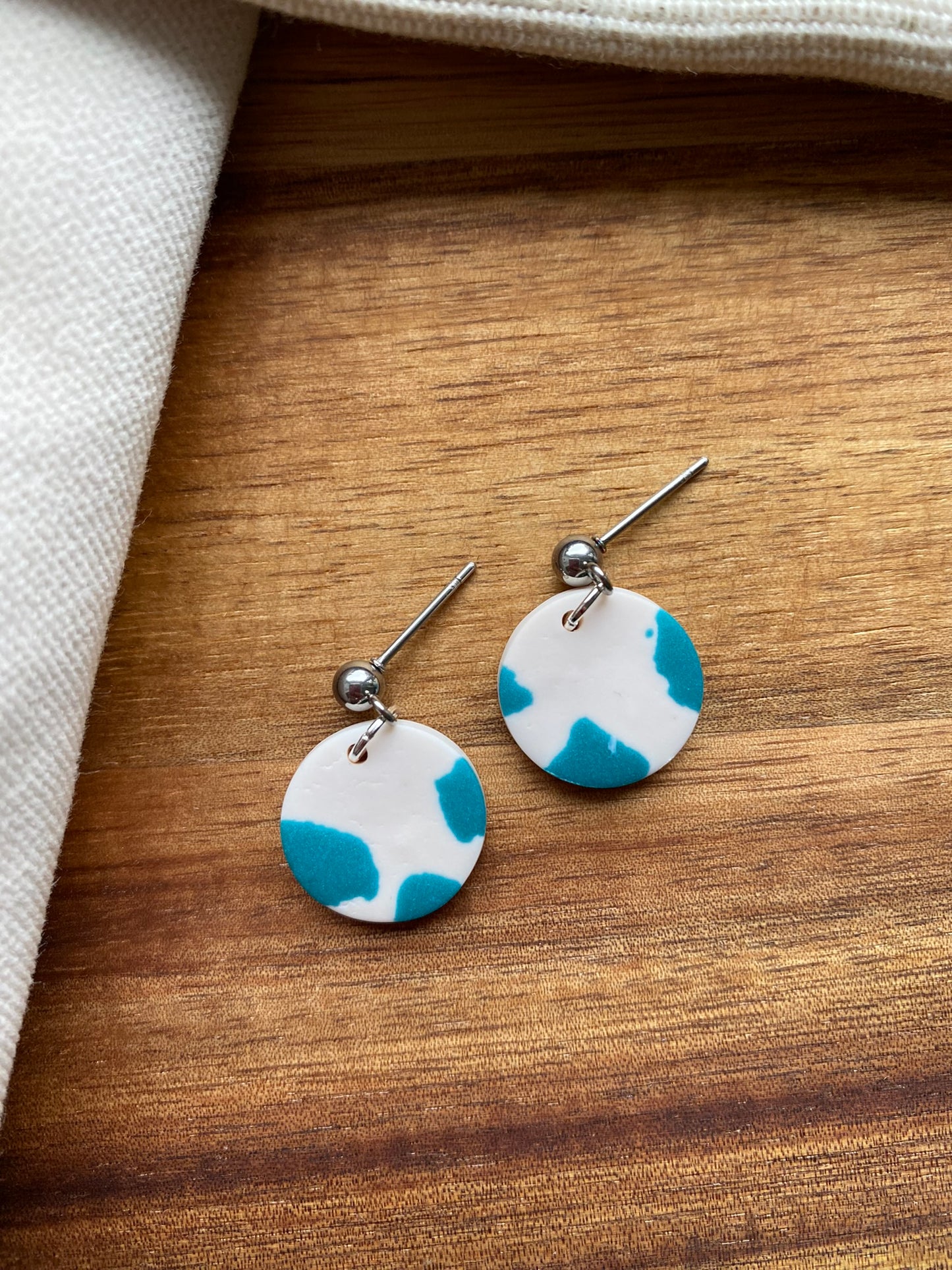 Dinky dangles - white and teal cow print circles