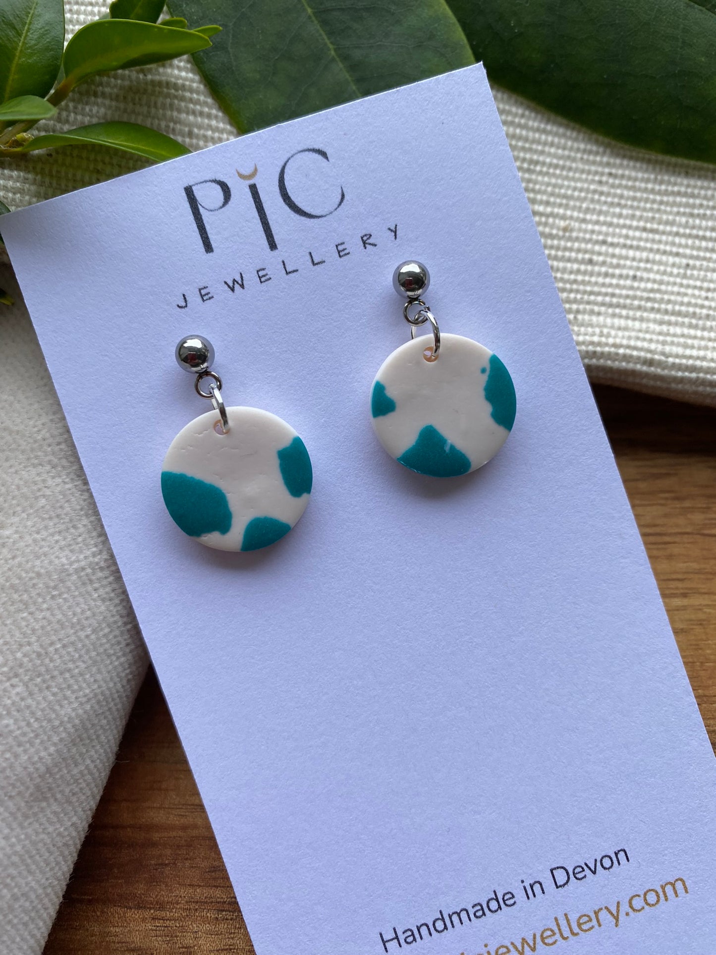 Dinky dangles - white and teal cow print circles